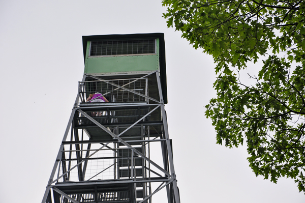 Karen Duquette climbing the Aiton Heights Fire Tower